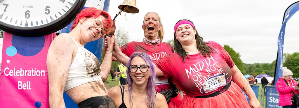 Pretty Muddy - Race for Life - ringing celebration bell.