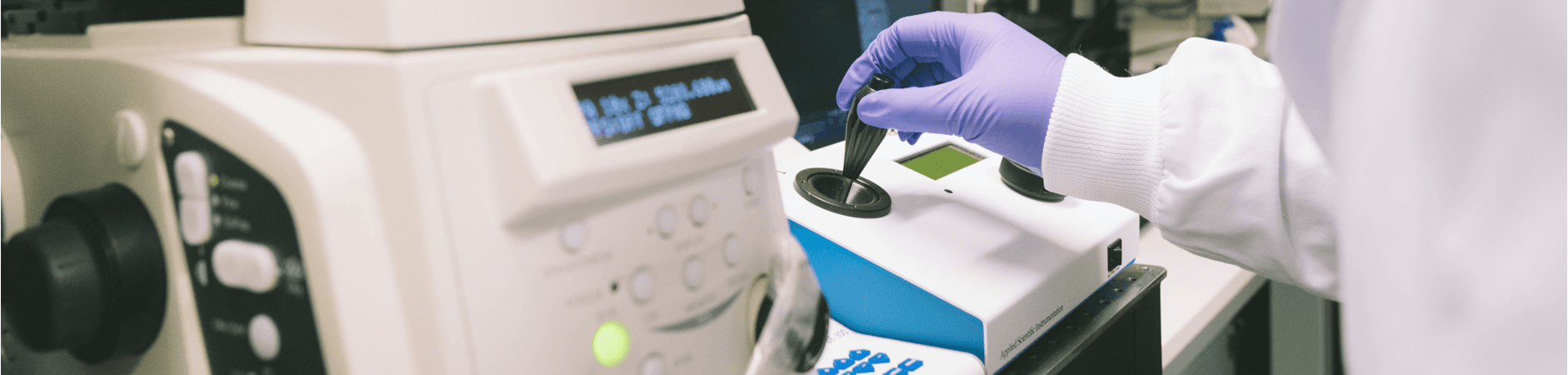 A scientist using a machine in the lab.