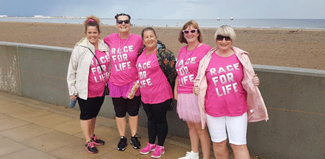 Group of Race for Life supporters on the beach completing their Race for Life at Home walk