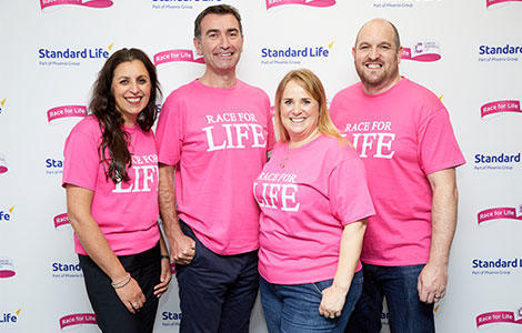 Four people wearing pink Race for Life T-shirts