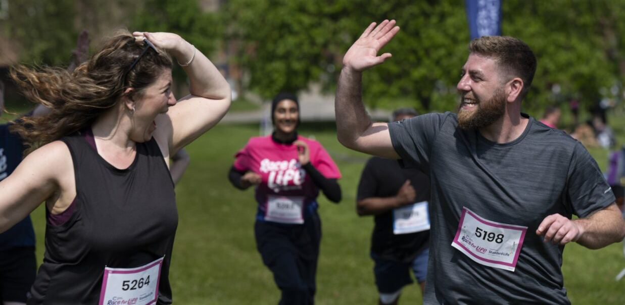 Two people high-fiving after completing the event