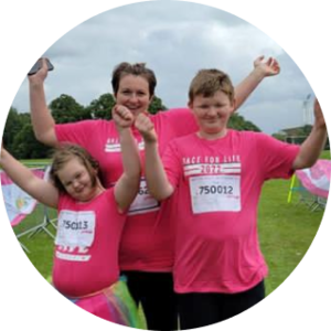 Ryan, Amy and their mum Sarah wearing pink t-shirts at a Pretty Muddy Kids event