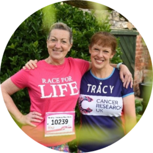 Tracy and her friend hugging and smiling wearing Race for Life t-shirts 